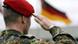 A German Bundeswehr soldier salutes the flag