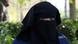 Selma, a 22 year old woman, wears the niqab as she sits in a park in Brussels