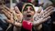 A Libyan woman reacts with her hands written on them in Arabic " I love Libya' as she joins a rally in support of the allied air campaigns against the forces of Moammar Gadhafi in Benghazi, eastern Libya, Wednesday, March 23, 2011